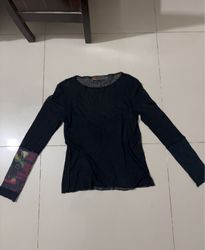Black long sleeve mesh shirt with graphic print on..
