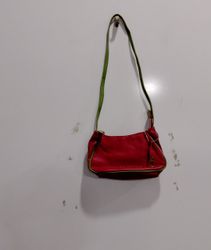 Red shoulder bag with green trim