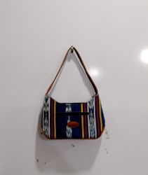 Striped shoulder bag with leather accents