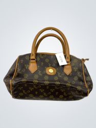 Braune Handtasche mit hellbraunen Akzenten und wie..