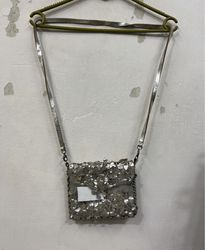 Silver bag with floral embellishments and tag BC-3..