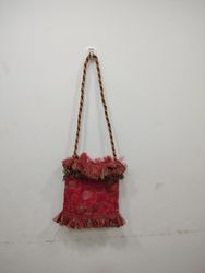 Red embroidered bag with ruffled trim
