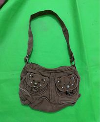Brown canvas shoulder bag with decorative studs