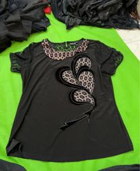 Black top with lace sleeves and embellished front,..