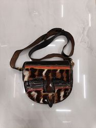 Brown leather crossbody bag with fur accents
