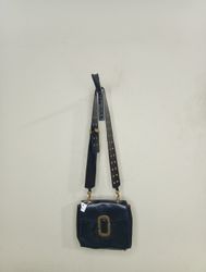 Black handbag with gold buckle and studded strap