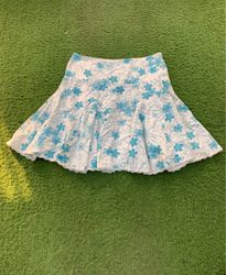 White skirt with blue floral embroidery
