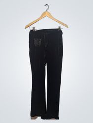 Pantaloni in velluto nero con decorazioni