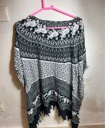 Black and white patterned poncho with fringe