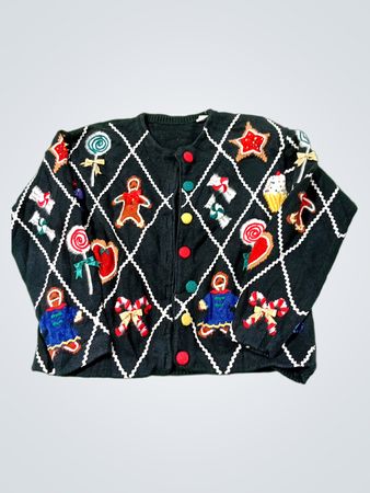 Pull de Noël noir avec des appliqués bonhomme en pain d'épice, canne en sucre et étoile