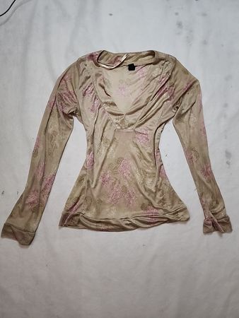 Long-sleeved beige top with pink floral pattern