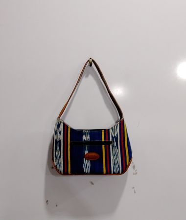 Striped shoulder bag with leather accents