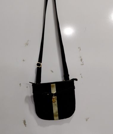 Black crossbody bag with gold stripe