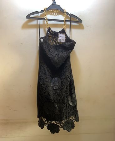 Schwarzes Spitzenkleid mit goldenen Kettendetails