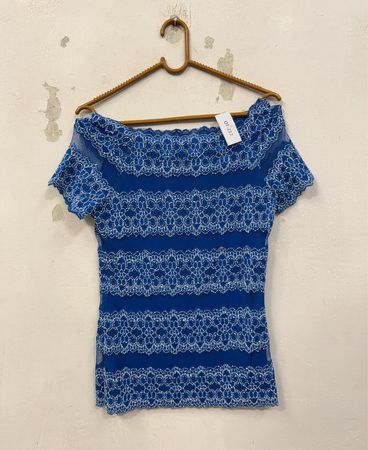 Bluse mit blauen Spitzen.