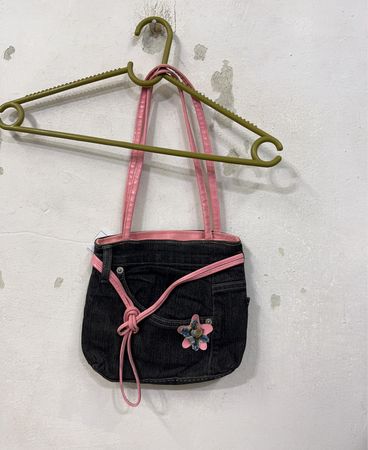 Denim-Handtasche mit pinken Riemen und Blumenakzent