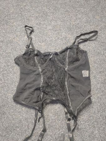 Black lace and mesh corset with garter straps