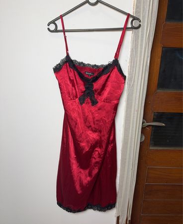 Red satin slip dress with black lace trim