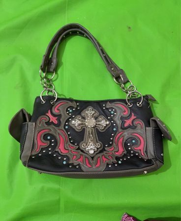 Black handbag with ornate cross embellishment