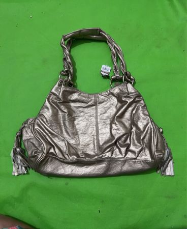 Metallic handbag with braided straps and tassels