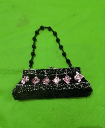 Black beaded clutch with pink floral embellishments