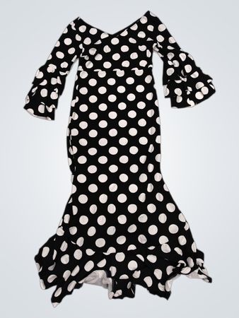 Schwarzes und weißes gepunktetes Kleid mit voluminösen Ärmeln und Saum.