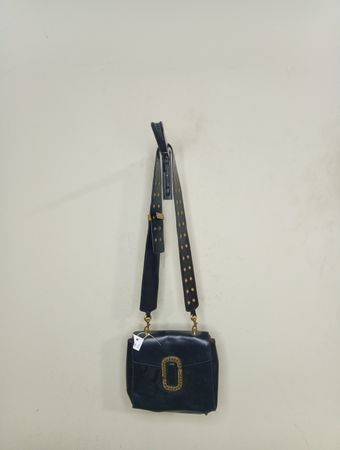 Black handbag with gold buckle and studded strap