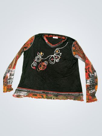 Black long sleeve top with colorful print on sleeves and embroidered design on front