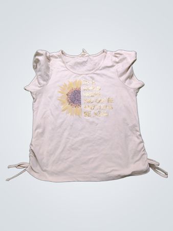 Cremefarbenes T-Shirt mit Sonnenblumen-Grafik und dem Text "In einer Welt, in der du alles sein kannst, sei freundlich