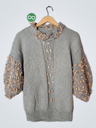Grey knit sweater with puffed sleeves and decorative buttons