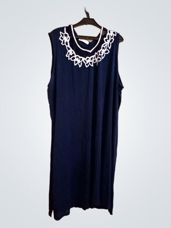 Ärmelloses dunkelblaues Kleid von Capricci mit weißem Blumen-Ausschnitt.
