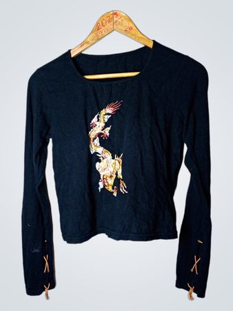 Black long sleeve top with embroidered dragon design and criss-cross detail on sleeves