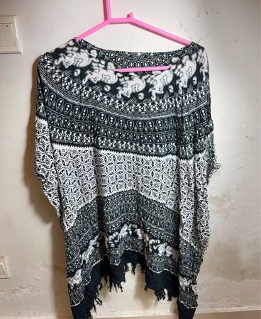 Black and white patterned poncho with fringe