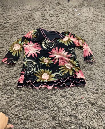 SKYE entwirft ein Oberteil mit floralen Druck und Rüschensaum.