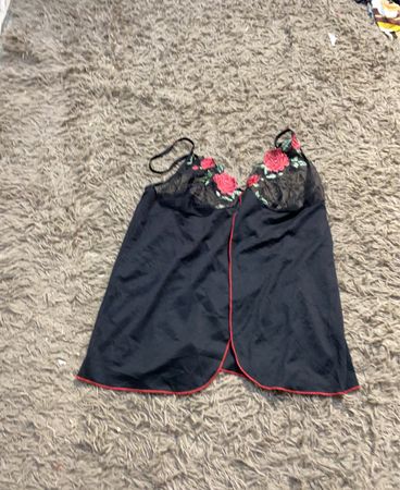 Schwarzes Top mit rotem Saum und floralem Stickerei