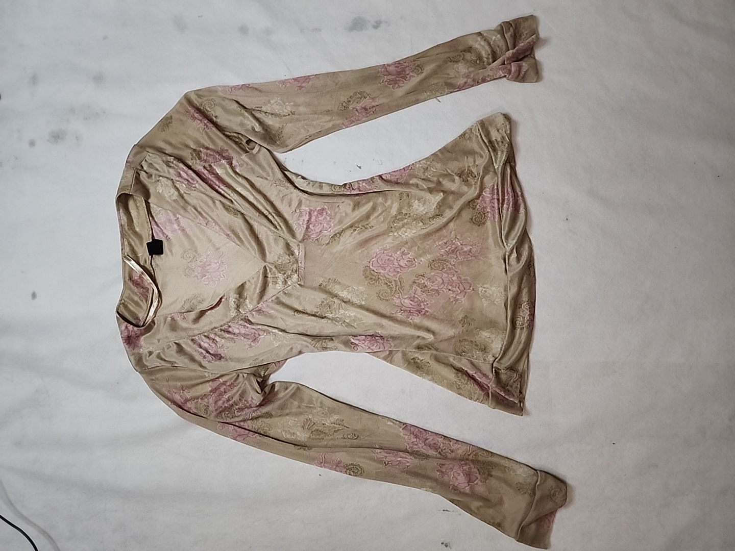 Long-sleeved beige top with pink floral pattern