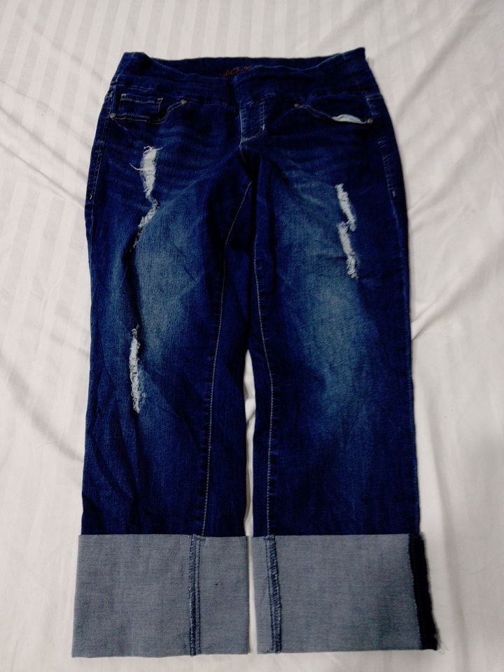 Distressed Dark Blue Jeans with Light Blue Hem